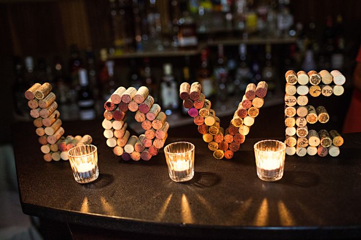 Word love made out of corks on a counter covered with romantic tea light candles